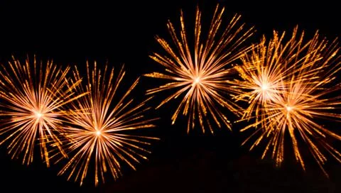 Bright lights of firework in dark night sky. Stock Photos