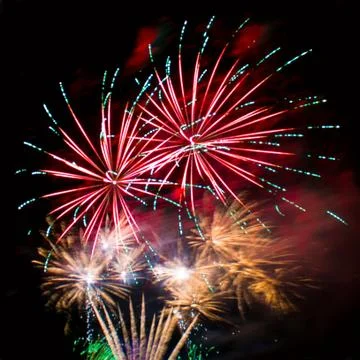 Bright lights of firework in dark night sky. Stock Photos