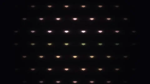 Bright lights form patterns on a dark background in a grid Stock Footage 338327884