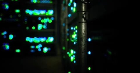 Bright lights illuminate servers in a data center during nighttime operations Illustrazione stock