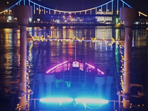 Bright lights of the night city reflected on a river view from, party ship Stock Footage 71864415