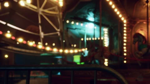 Bright lights shine on a carnival ride at nighttime in an amusement park Vídeo Stock 344844584