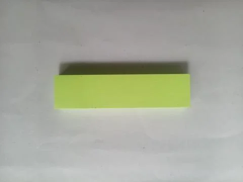 Bright Lime Green Sticky Note Pad on White Background Stock Photos