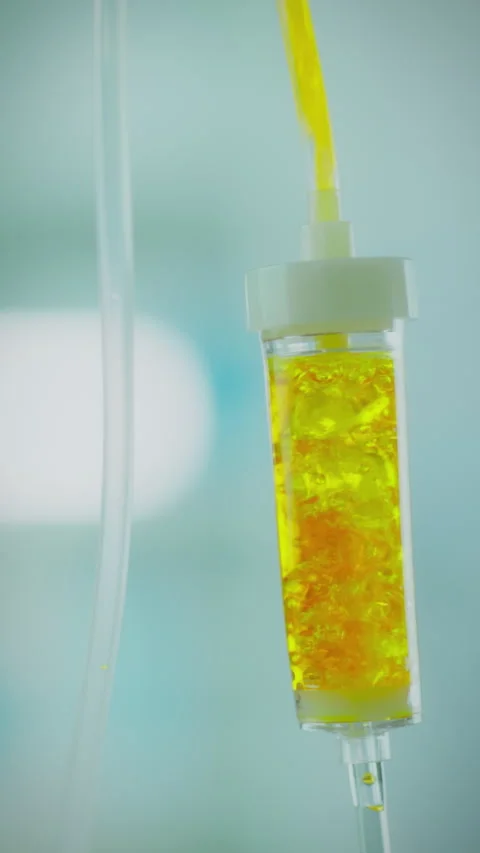 Bright liquid drips slowly from IV in a medical facility highlighting patien Stock Footage 331535953