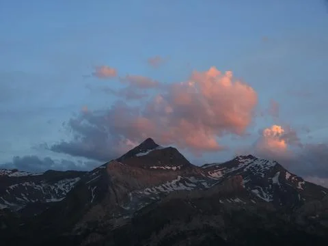 Bright lit evening cloud over the Les Diabletets range. Stock Photos