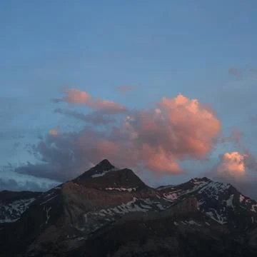 Bright lit evening cloud over the Les Diabletets range. Stock Photos