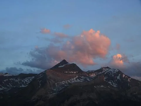 Bright lit evening cloud over the Les Diabletets range. Bright lit evening... Stock Photos