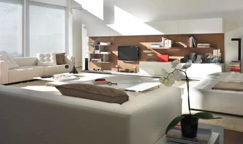 Bright living room with white sofas, wood floor and white tables Stock Photos