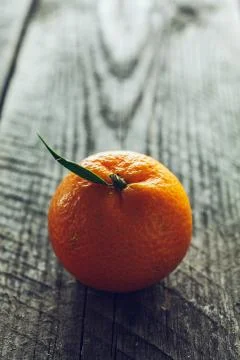 Bright mandarin with small green leaf Stock Photos