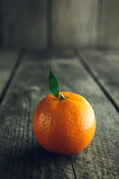 Bright mandarin with small green leaf Stock Photos
