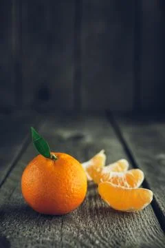 Bright mandarin with small green leaf Stock Photos