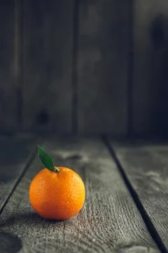 Bright mandarin with small green leaf Stock Photos