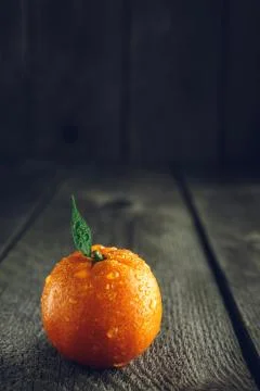 Bright mandarin with small green leaf Stock Photos