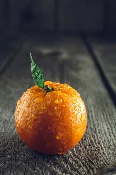 Bright mandarin with small green leaf Stock Photos