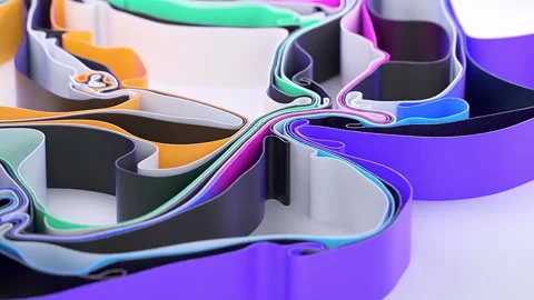 Bright matte ribbons moving endlessly on a white surface, abstract background Stock Footage 136571032