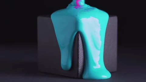 Bright mixed paints runs down the black cube. Pink and blue mixed liquid dr.. Stock Footage 245144590