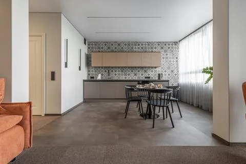 Bright Modern Kitchen with Patterned Wall Tiles and Black Furniture Stock Photos