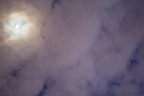 Bright Moon Behind a Sheet of Clouds Stock Photos