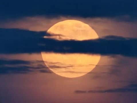Bright Moon Emerging Among Thin Clouds, Luminous Orange Moon Breaking Through Stock Photos