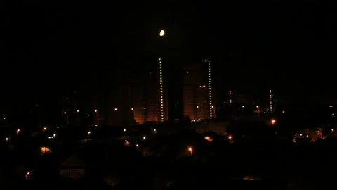 Bright moon move down in night town Stock Footage 148421436