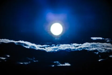 Bright moon over clouds at night Stock Photos