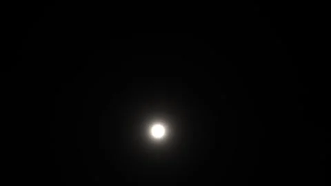 Bright moon shines in dark night sky with soft clouds Video stock 338330359