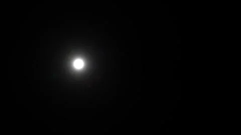 Bright moon shining in dark night sky with some clouds Video stock 338129877