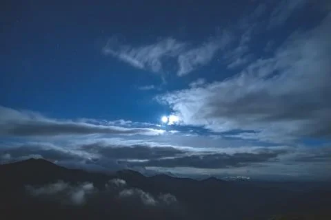 The bright moon in the starry sky on the cloud background Stock Photos