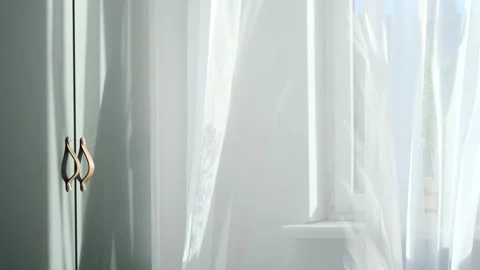 Bright morning sun in the open window through the curtains. Abstract white Stock Footage 150296477