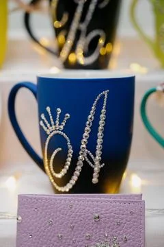 Bright mug with gradient and decorative rhinestone pattern, close-up view Stock Photos