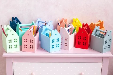 Bright multi-colored boxes in the shape of houses for storing pens, felt-tip Stock Photos