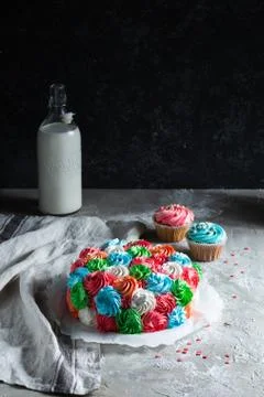 Bright multi-colored cake with flowers on a gray background Stock Photos