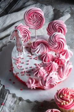 Bright multi-colored cake with flowers on a gray background Stock Photos