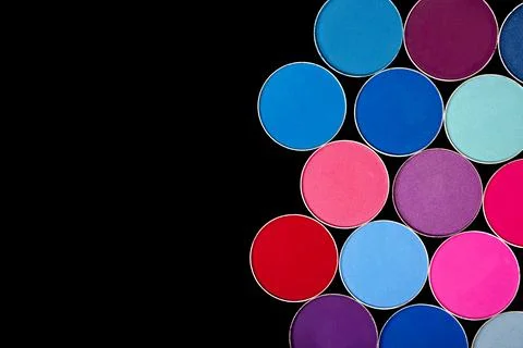 Bright multi-colored eye shadow palette, on a black isolated background Stock Photos
