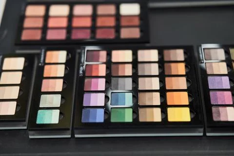 Bright multi-colored eye shadow. Professional makeup for make-up artists Stock Photos