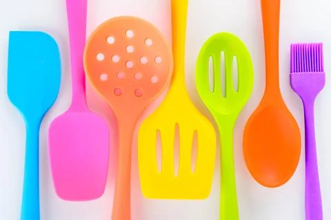 Bright multi colored kitchen utensils on white background Stock Photos