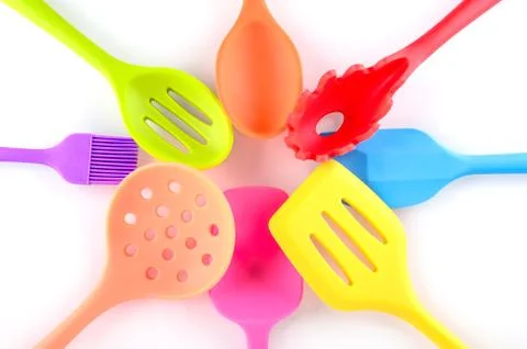 Bright multi colored kitchen utensils on white background Stock Photos