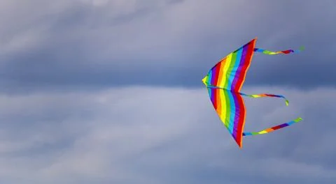 Bright multi-colored kite in free flight above the ground Stock-Fotos