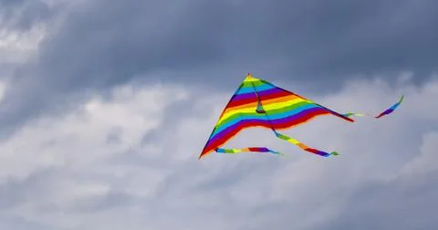 Bright multi-colored kite in free flight above the ground Stock-Fotos