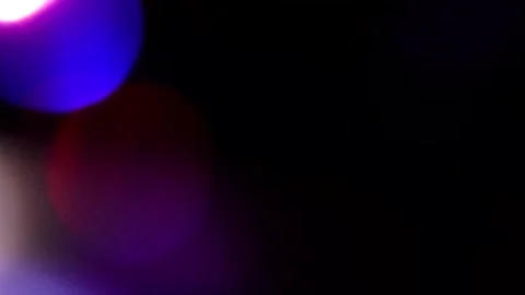 Bright multi-colored light next to each other in the blackness on the left 库存影片 309426503