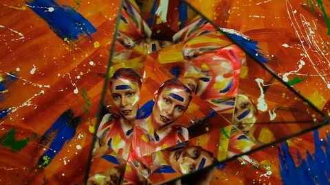 Bright multi-colored paint on the body of a young beautiful woman Stock Footage 124024629