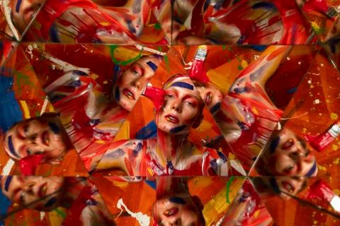 Bright multi-colored paint on the body of a young beautiful woman. Carnival Stock-Fotos