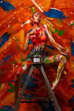 Bright multi-colored paint on the body of a young beautiful woman. Carnival Stock-Fotos