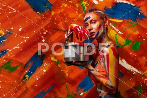 Bright multi-colored paint on the body of a young beautiful woman. Carnival Stock Photos