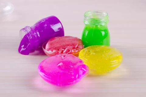 Bright multi colored slimes on a table. Kids popular toy of nowadays. Slime i Stock Photos