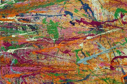 Bright multi-colored spots and splashes of paint on the wall closeup. rough s Foto stock