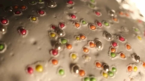 Bright multi-colored sprinkles on an Easter cake Stock Footage 191028480