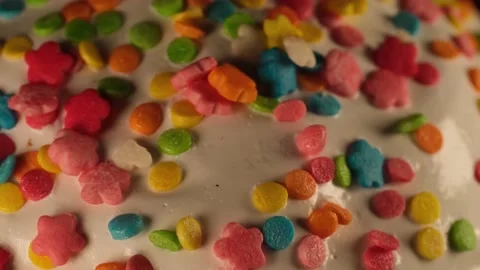 Bright multi-colored sprinkles on an Easter cake Stock Footage 191032546