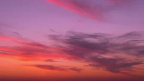 Bright multi colored sunset sky sun and gentle colorful clouds fast time lapse h 库存影片 326791217