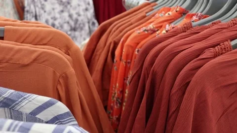Bright multi-colored women's shirts on a hanger in the store. Stock Footage 203909434